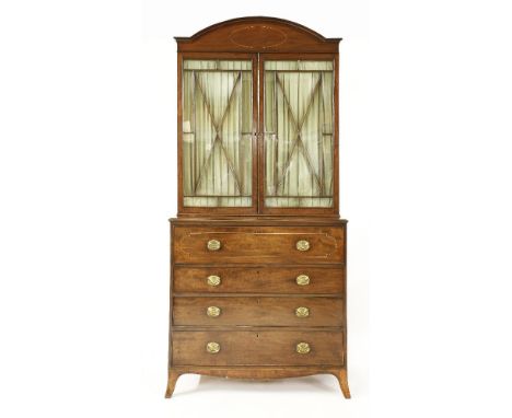 A George III strung mahogany secretaire bookcase,the arched cornice above two doors, with reeded trellis pattern astragal gla