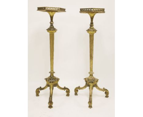 A pair of Chippendale-style carved limewood and purple heart gilt torchères,early 19th century, the hexagonal galleried tops 
