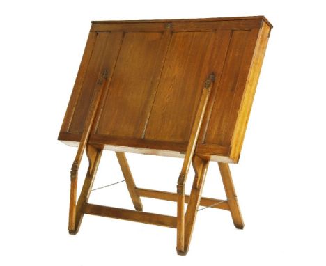 A Victorian oak folio stand,with an hinged top and decorative brass hinges,115cm wide117cm high