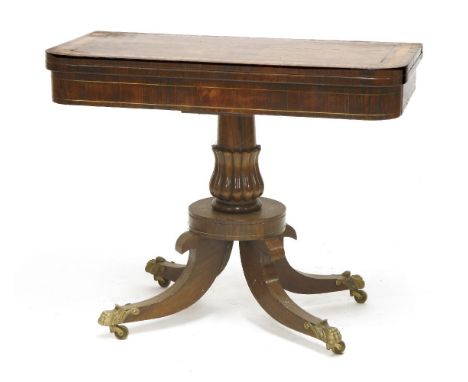 A rosewood crossbanded and brass inlaid card table,19th century, the fold-over top on a tulip-shaped carved support, four sab