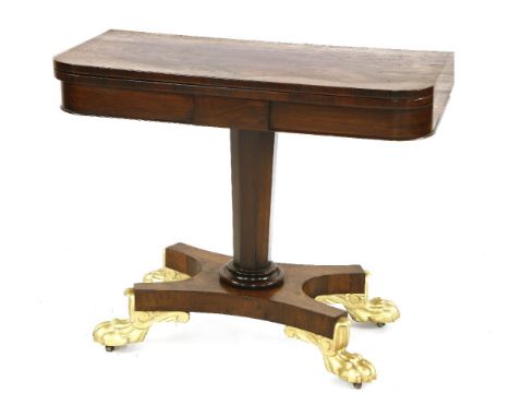 A Regency rosewood fold-over card table,on a platform base and gilded paw feet,90cm wide45cm deep73cm high