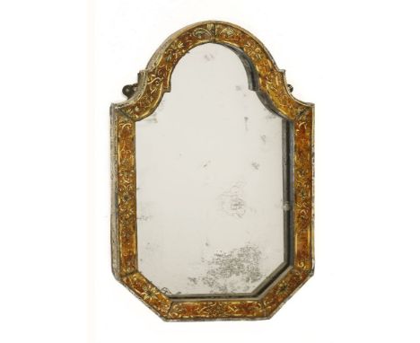 A Continental wall mirror,  r18th century, the shaped verre églomisé frame decorated with a fleur-de-lys crest and repeating 