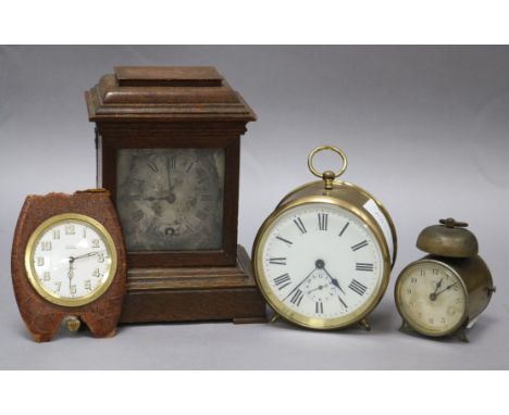 Two alarm clocks, a travel clock and a re-cased movement, 17cm