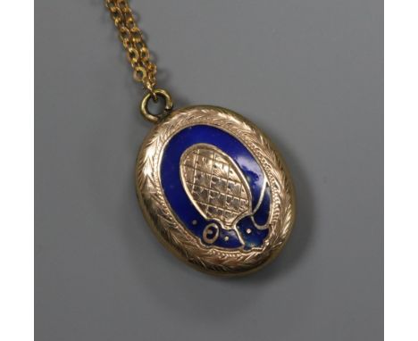 An early 20th century yellow metal and enamel oval locket with glazed back, on a later 9ct gold chain, locket 20mm.