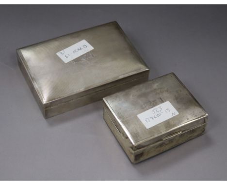 Two engine turned silver cigarette boxes, largest 16.3cm.