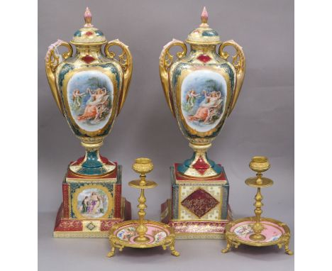 A pair of Austrian style lidded urns and a pair of gilt and ceramic candlesticks urns height 41cm