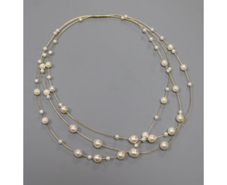 A modern 14ct and cultured pearl triple strand necklace, approx. 34cm.