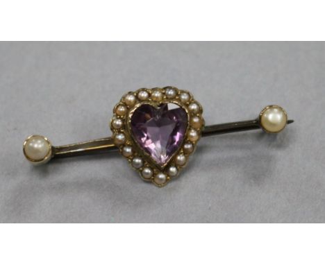 A early 20th century yellow metal, heart shaped amethyst and seed pearl bar brooch, 39mm.