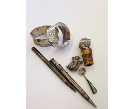 Seven various silver items including napkin rings, pencils and an engine turned bottle stopper.