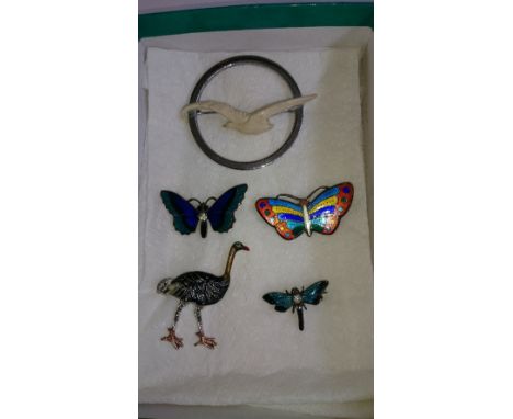 Four various enamel brooches together with an Art Deco style seagull brooch.