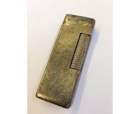 A silver plated engine turned Dunhill cigarette lighter.