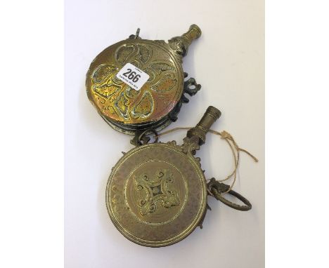 A 19th century Moroccan brass powder flask with engraved decoration together with another.