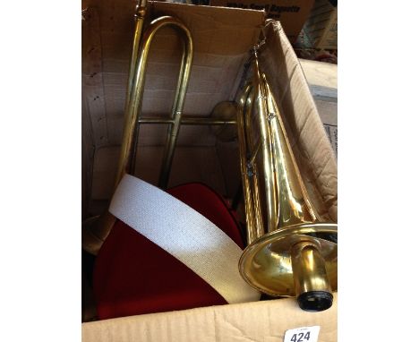 A pair of brass trumpet wall light fittings together with a military cap.