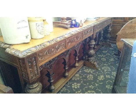 A massive country house carved oak six drawer buffet standing on carved Baluster supports with eight arch carving balustrade 