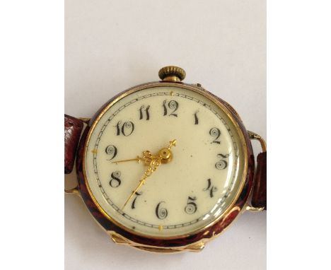 A 14K gold ladies wrist watch with enamel back (converted from a fob watch).