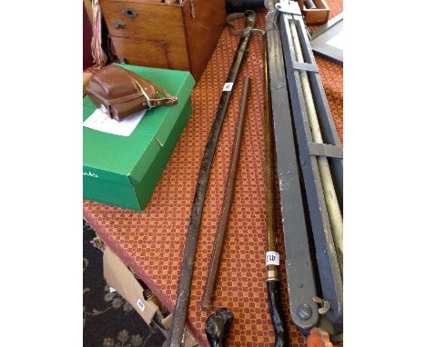 A sword in metal scabbard together with a leather baton.