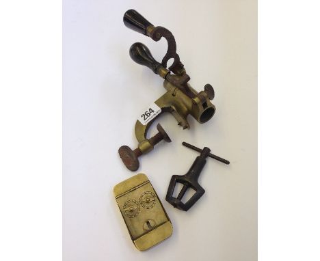 A brass bullet mould together with a small brass counter and one other shooting related item.