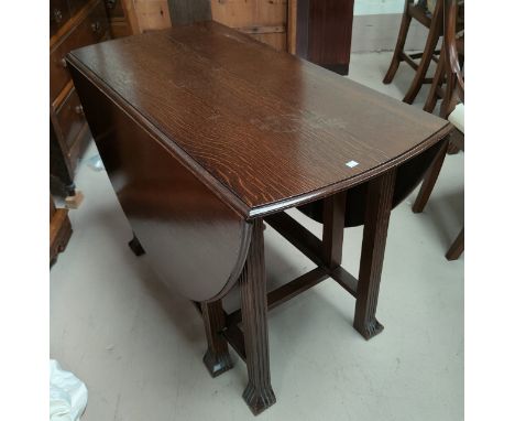 A 1930's oak dining table with oval dropleaf top, on square reeded legs; a set of 5 (4 + 1) ladder back chairs 