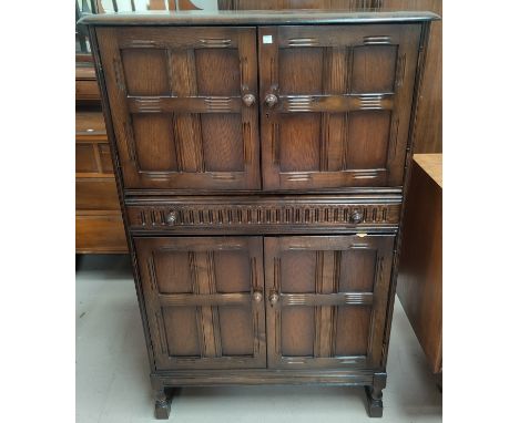 An Ercol traditional style cocktail cabinet, fitted cupboards and central drawer, 82 cm 