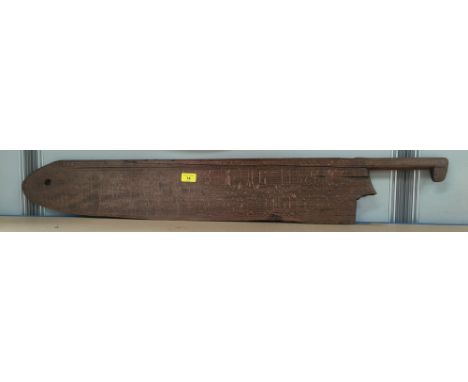 An antique wooden farmer's wheat shearing tool 