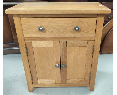 A modern side cupboard in light polished oak, 70 cm 