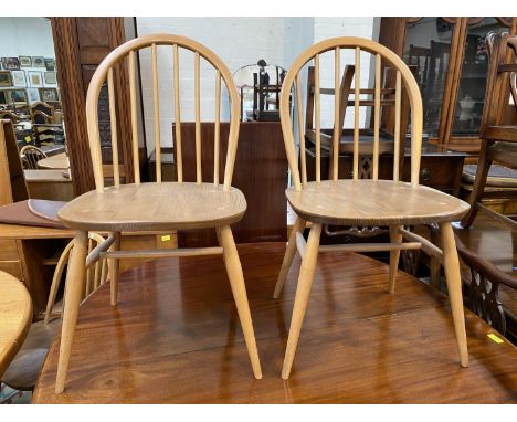 A set of 4 Ercol lightwood and elm hoop and stick back dining chairs 