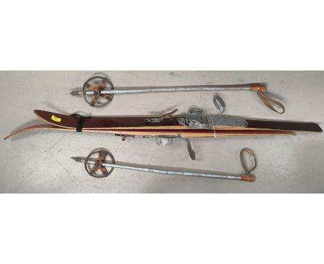 A pair of vintage Sport ALM children's skis and poles 