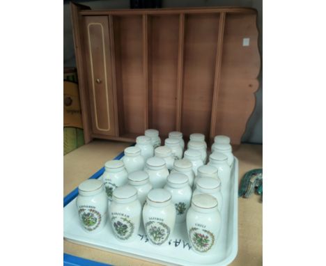 A wall mirror in rectangular frame; a wall mirror in oval frame; a spice rack and bottles 