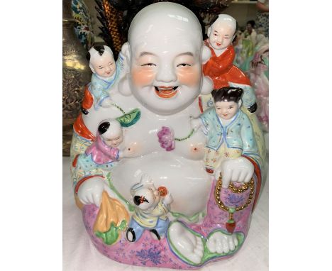 A Chinese figure of seated Hoti with children playing on him, height 28cm 