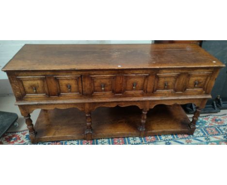 An Oak dresser base with three drawers, turned shelf, under shelf length 172cm depth 51cm height 86cm 