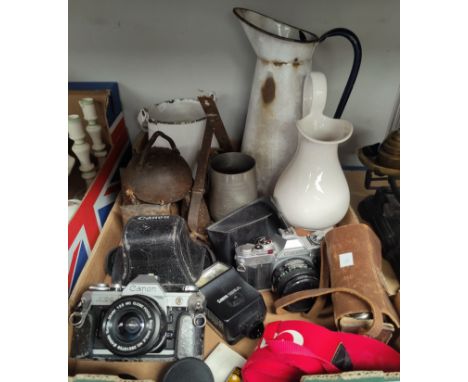 A hand operated sewing machine by Singer; a set of kitchen scales; 3 vintage cameras; cowbells; etc. 