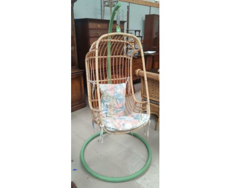 A 1960's cane hanging chair on stand 