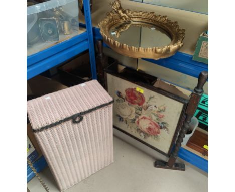 A Lloyd Loom small linen basket; an oak firescreen with tapestry panel; an oval gilt framed mirror 