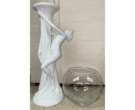 A large ceramic figure of woman in white holding a glass bowl on stand, a similar smaller figure 