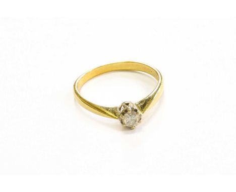 An 18 Carat Gold Diamond Solitaire Ring, the round brilliant cut diamond in a white claw setting, to a yellow tapered shoulde