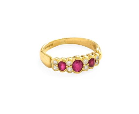 An 18 Carat Gold Synthetic Ruby and Diamond Ring, three graduated oval cut synthetic rubies alternate with pairs of round bri