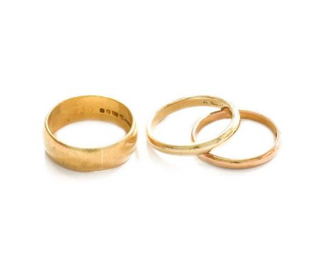 Two 22 Carat Gold Band Rings, finger sizes N and O; and A 9 Carat Gold Band Ring, finger size NTwo 22 carat gold band rings -