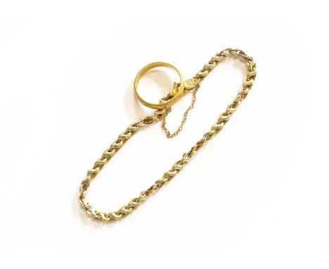 An 18 Carat Gold Band Ring, finger size R; and A Fancy Link Bracelet, stamped '375', length 21.5cmRing - 4.7 grams. Bracelet 