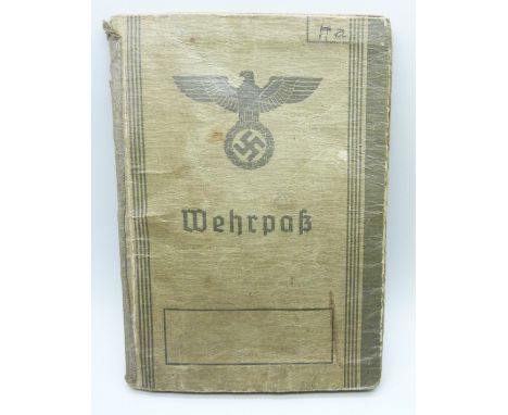 A German WWII soldiers army handbook, with many entries and stamps throughout the duration of the war
