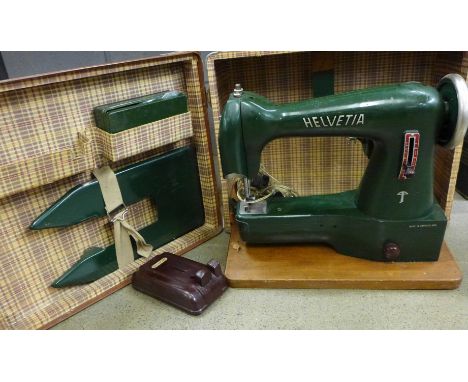 A vintage Helvitia sewing machine, cased **PLEASE NOTE THIS LOT IS NOT ELIGIBLE FOR IN-HOUSE POSTING AND PACKING**