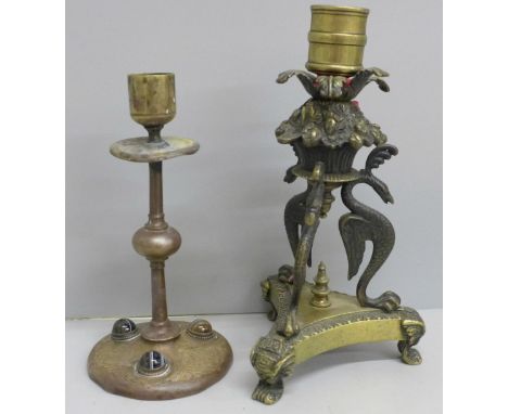 A Regency candlestick with phoenix detail and an early Victorian, (c.1845), candlestick in copper and brass set with bull's-e