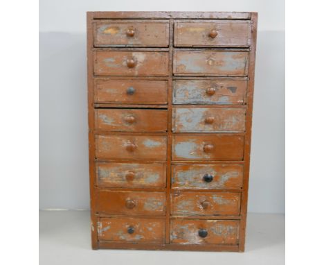 A watchmakers table-top chest of drawer with tools and parts, cases and movements