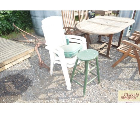 Two plastic garden chairs; an umbrella base and a wooden stool