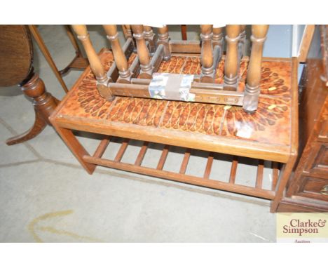 A teak and tile topped coffee table