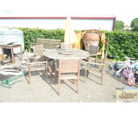 A teak garden table 6 chairs, lazy Susan and umbrella 