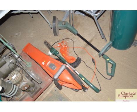 A Flymo garden vac; electric hedge trimmer and an electric strimmer