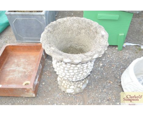 A pre cast garden urn with shell decoration