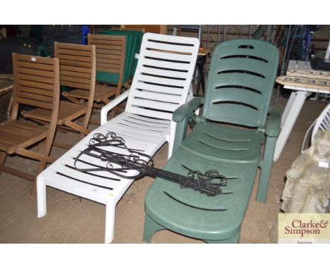 Two plastic garden loungers