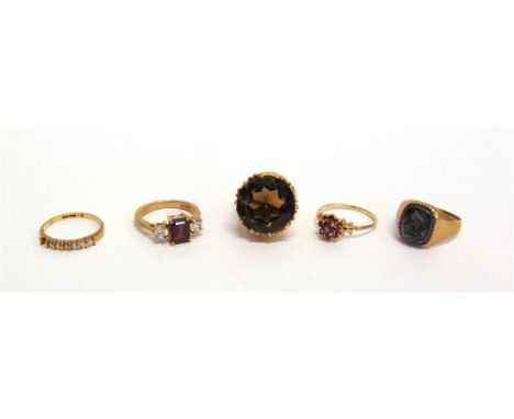 A 9 CARAT GOLD THREE STONE GARNET AND CUBIC ZIRCONIA DRESS RING a 9 carat gold ruby cluster ring; a 9 carat gold heamatite in