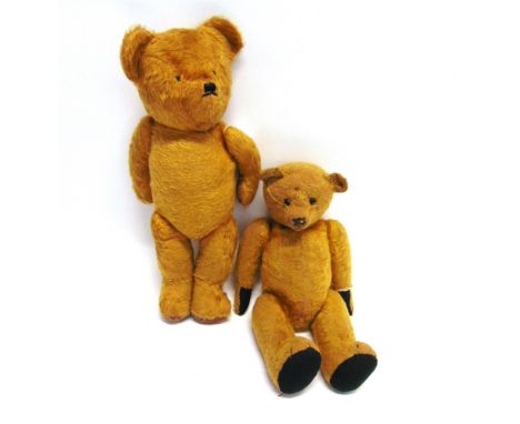 A GOLD PLUSH TEDDY BEAR  with boot button eyes, remains of a black vertically stitched nose and over-sewn pads, on a jointed 